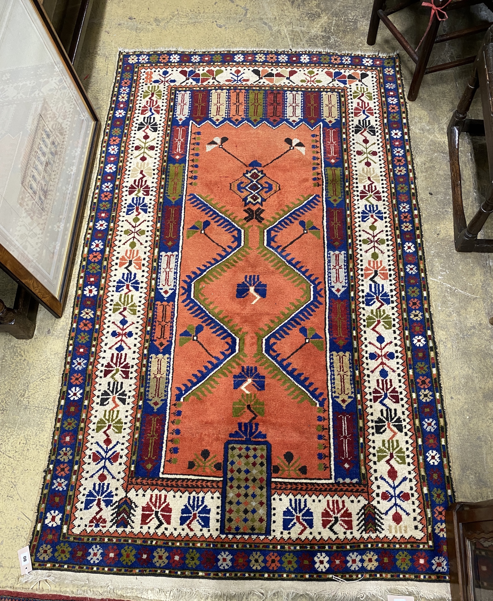 A Caucasian design red ground rug, 205 x 123cm